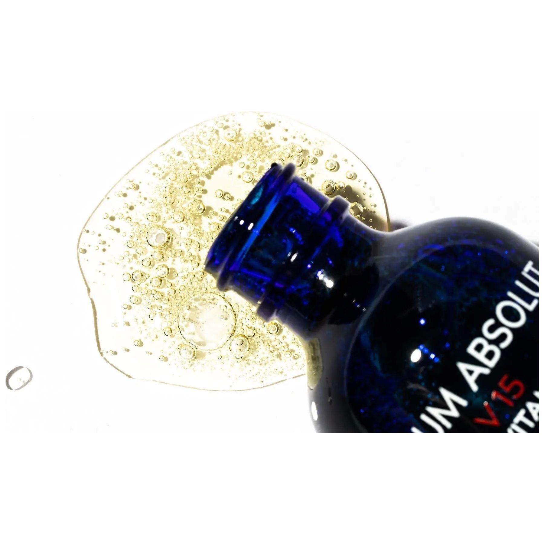 Serum spill from blue bottle, showcasing product texture and clarity