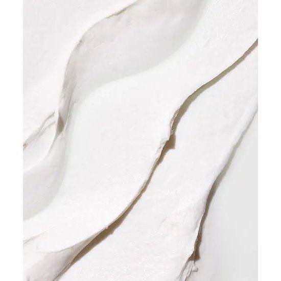 Close-up of smooth, white molding cream showcasing its rich, emollient texture for styling hair.