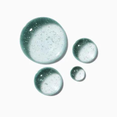 Clear and green gel droplets representing Kerastase Symbiose Sérum Nuit Intensif for revitalizing hair.