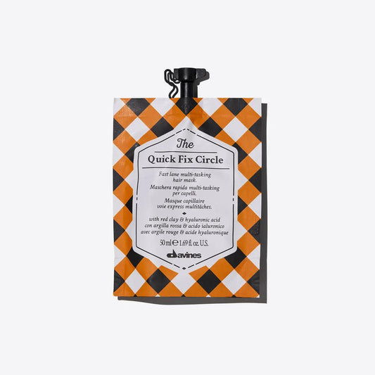 Davines The Quick Fix Circle multi-tasking hair mask pouch with a checkered design, ideal for quick hydration and detangling.