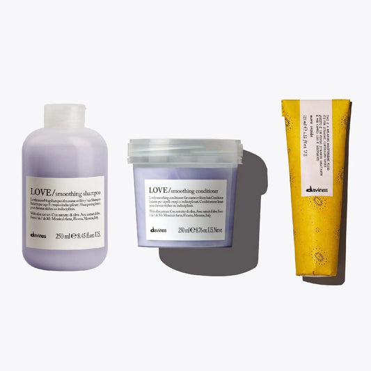 The Smooth Operator Set featuring LOVE smoothing shampoo, conditioner, and moisturizing fluid for frizz-free hair.