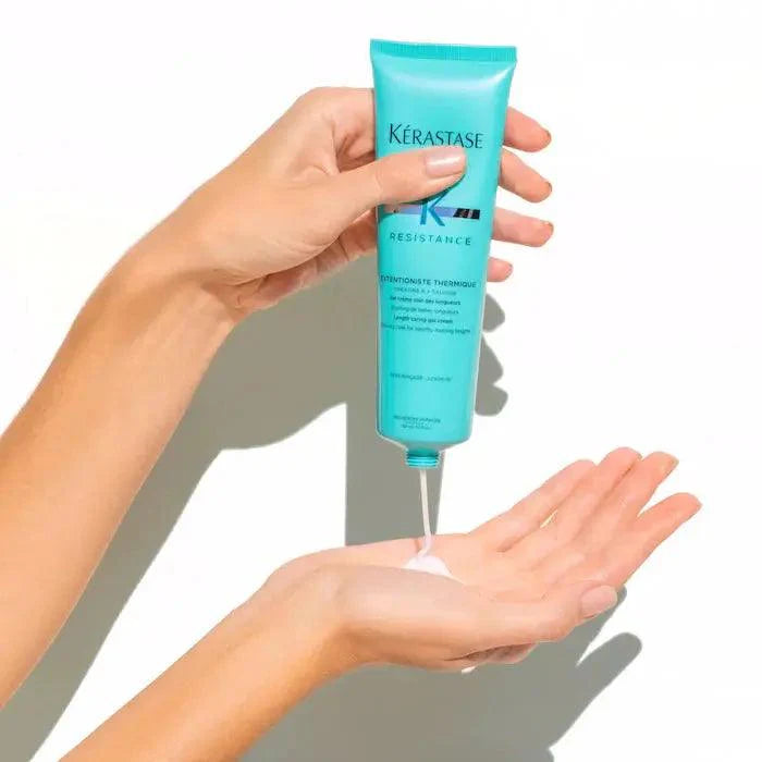 Applying Kérastase Resistance hair care treatment to hand for revitalized, healthy hair.