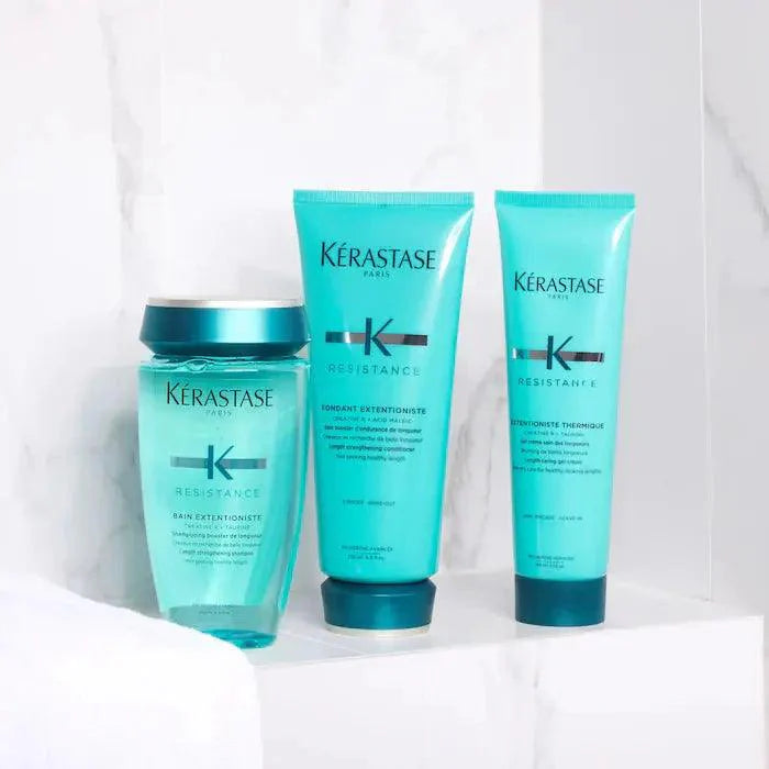 Kérastase Resistance hair care products for damaged hair, shampoo, conditioner, and treatment set on a marble surface.