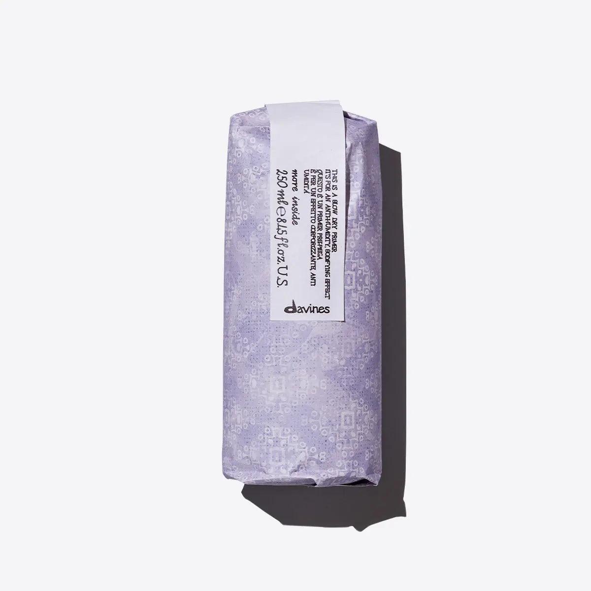 Davines Blow Dry Primer packaging in lavender, showcasing anti-humidity and heat protectant benefits for hair.