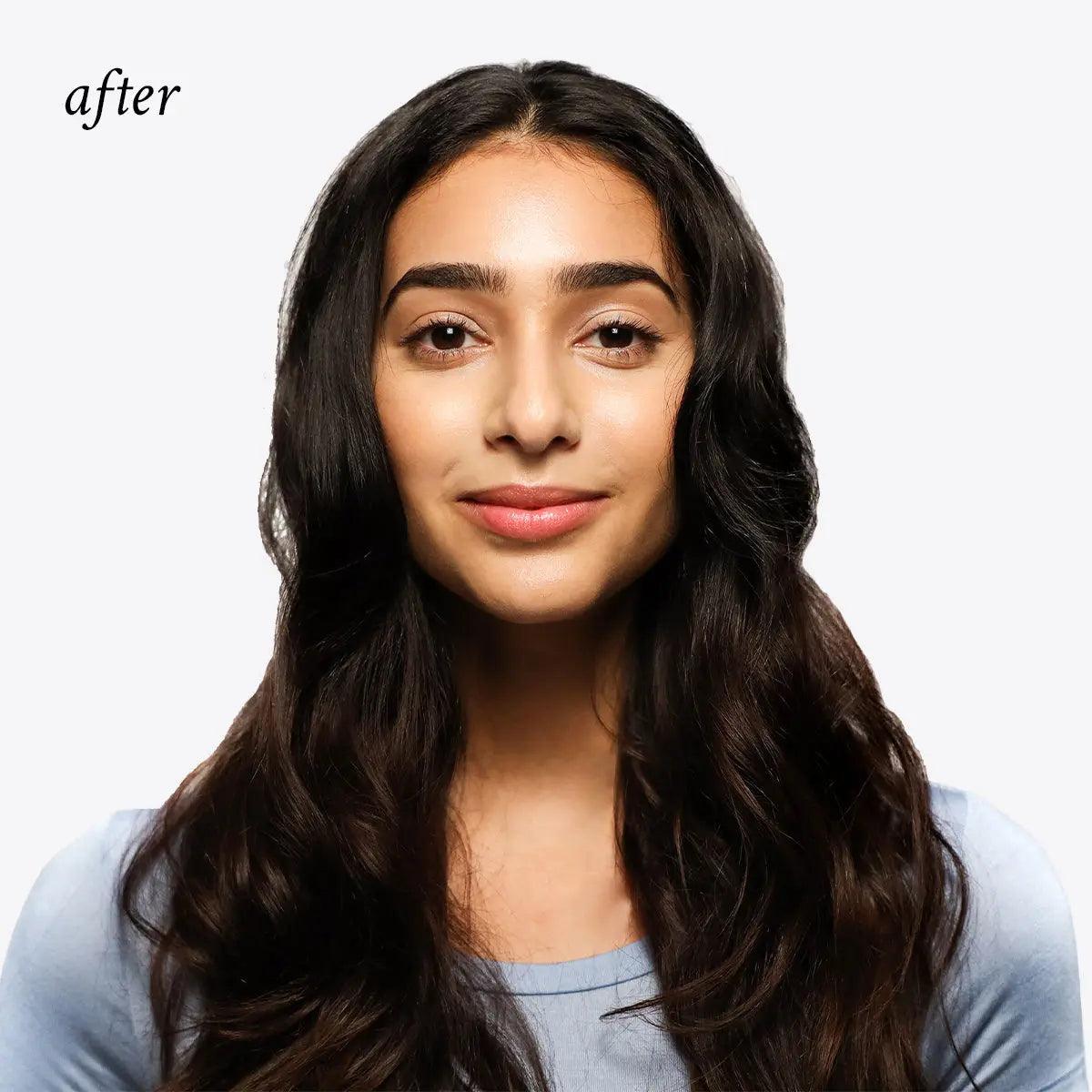 Woman with silky, voluminous hair after using invisible dry shampoo for a fresh and natural look.
