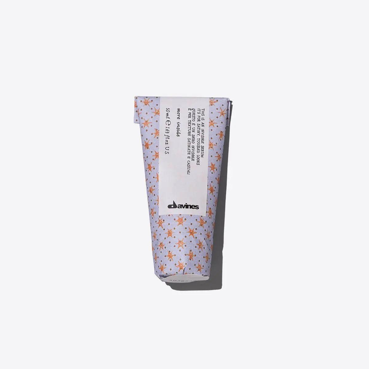 Davines hair product tube with floral design on white background