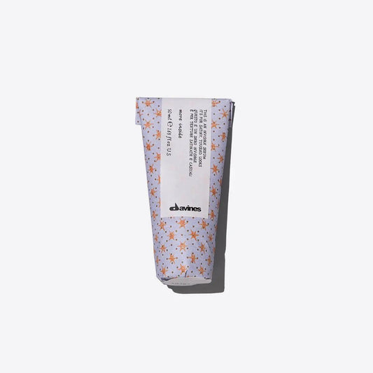 Davines hair product tube with floral design on white background