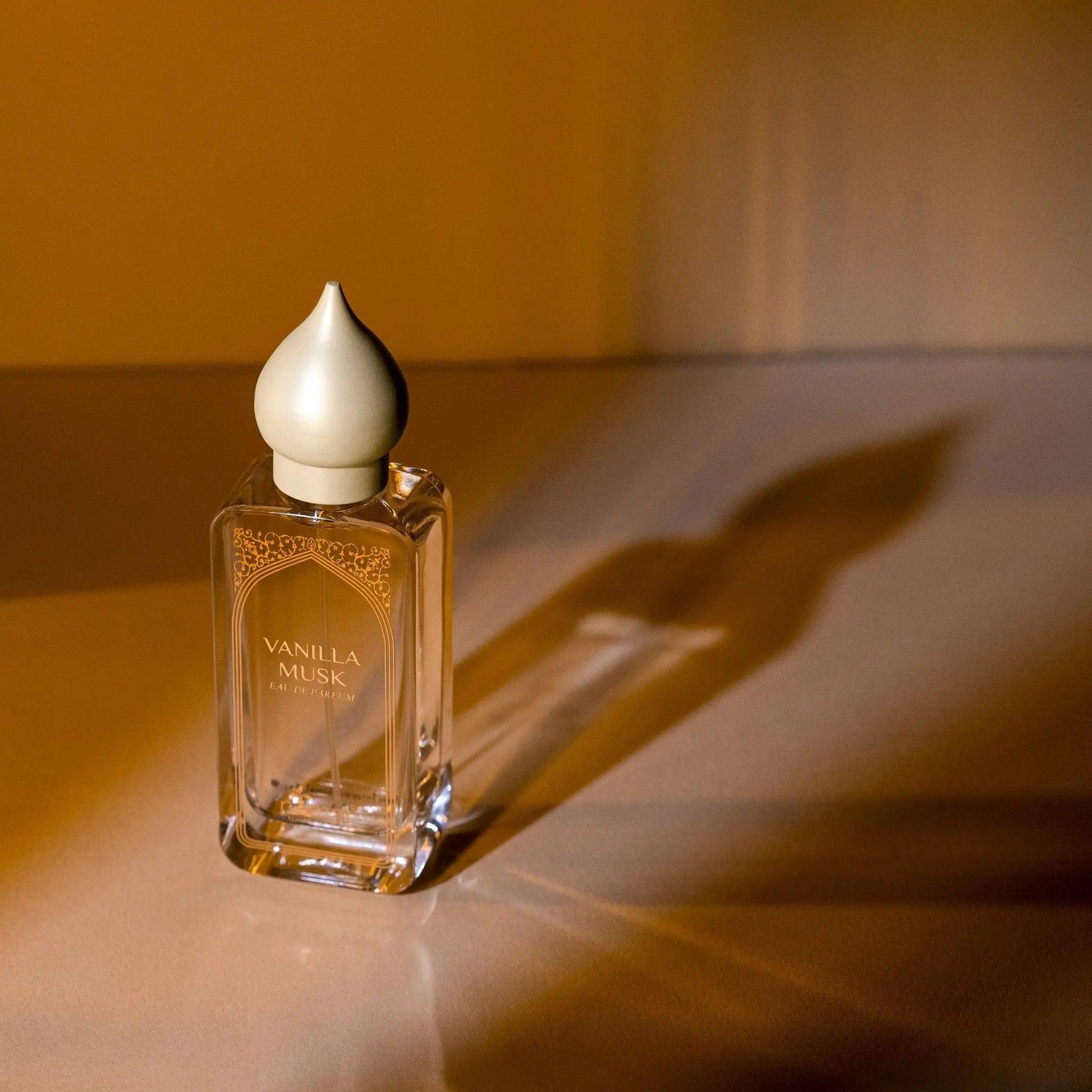 Elegant bottle of Vanilla Musk Eau De Parfum on a soft surface, highlighting its unique design and enticing scent.