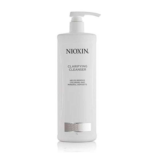 Nioxin Clarifying Cleanser in a pump bottle, designed to remove chlorine and mineral deposits from all hair types.
