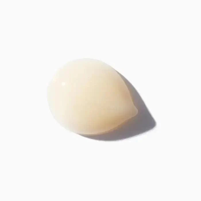 Clear golden skincare serum drop on white background