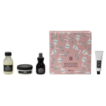 Davines Oi Travel Gift Set featuring shampoo, conditioner, leave-in milk, and hand balm in a decorative box.