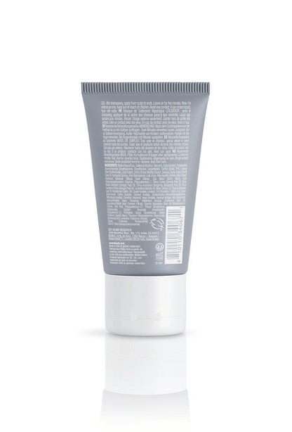 Back view of Neu Repair Treatment Masque tube displaying ingredient list and label for hair repair and nourishment.