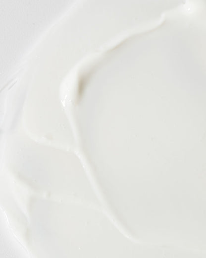 Close-up of creamy Age-Defying Body Lotion, highlighting its smooth texture and hydrating formula.