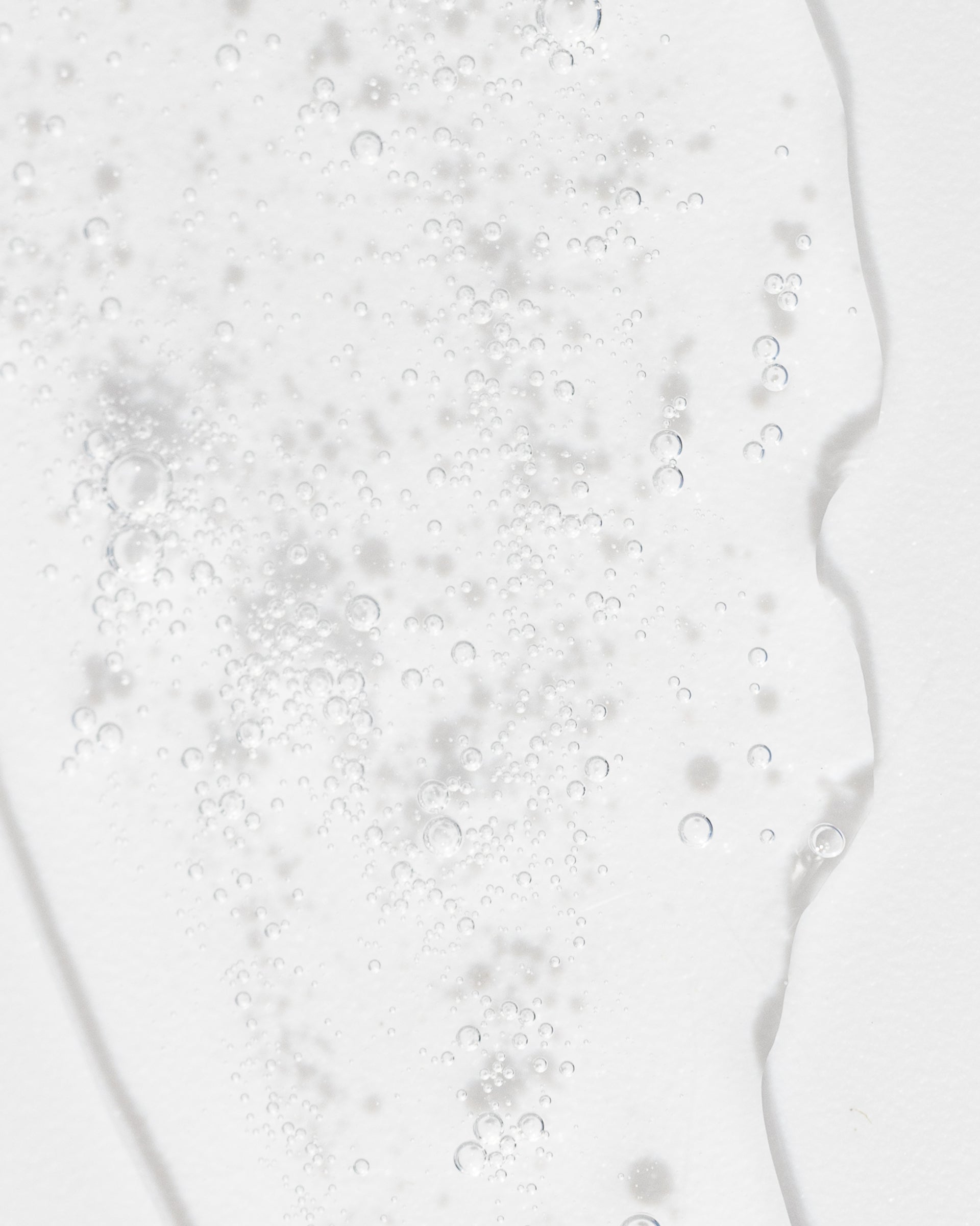 Close-up of refreshing toner texture with bubbles, showcasing its gentle, hydrating properties for skin care.