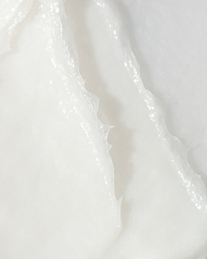 Close-up of smooth, white skin brightening cream texture, highlighting its hydrating and brightening properties.