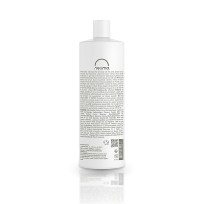 Back view of Neuma Re Neu Clarifying Shampoo bottle showcasing product information and ingredients.