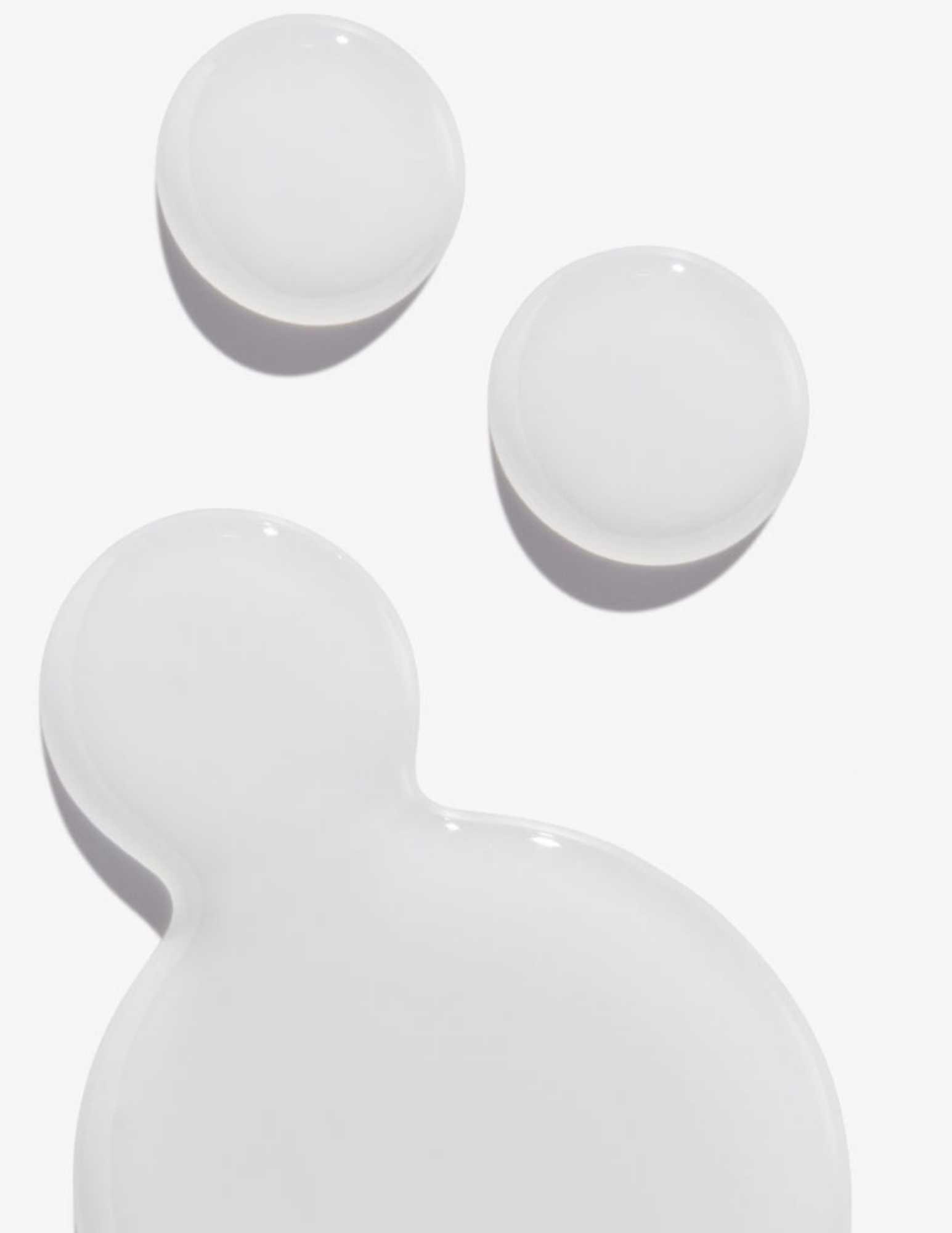 Clear gel texture of a hair treatment, showcasing smoothness and light reflection.