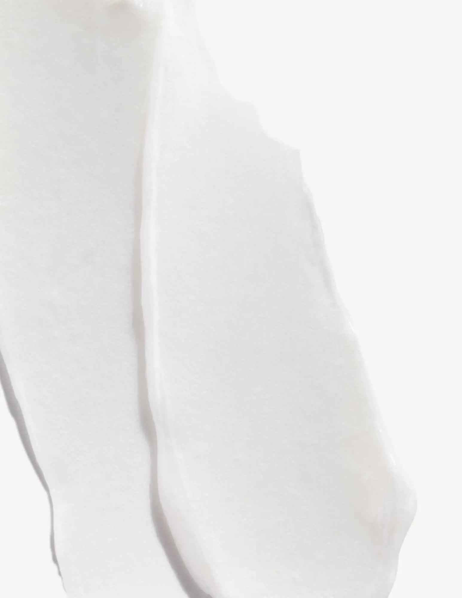 Smooth, creamy texture of Acidic Bonding Concentrate Conditioner on a white background.