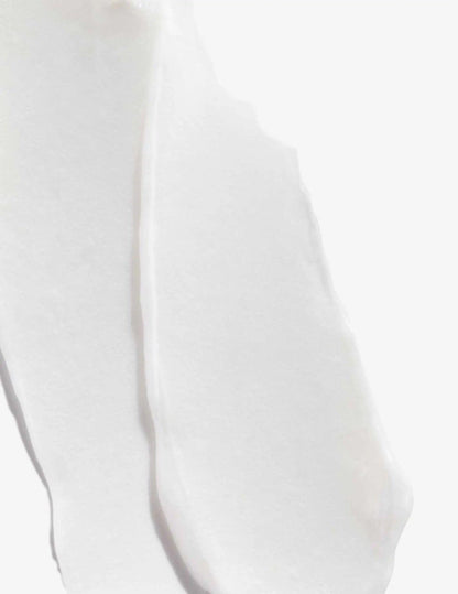 Smooth, creamy texture of Acidic Bonding Concentrate Conditioner on a white background.