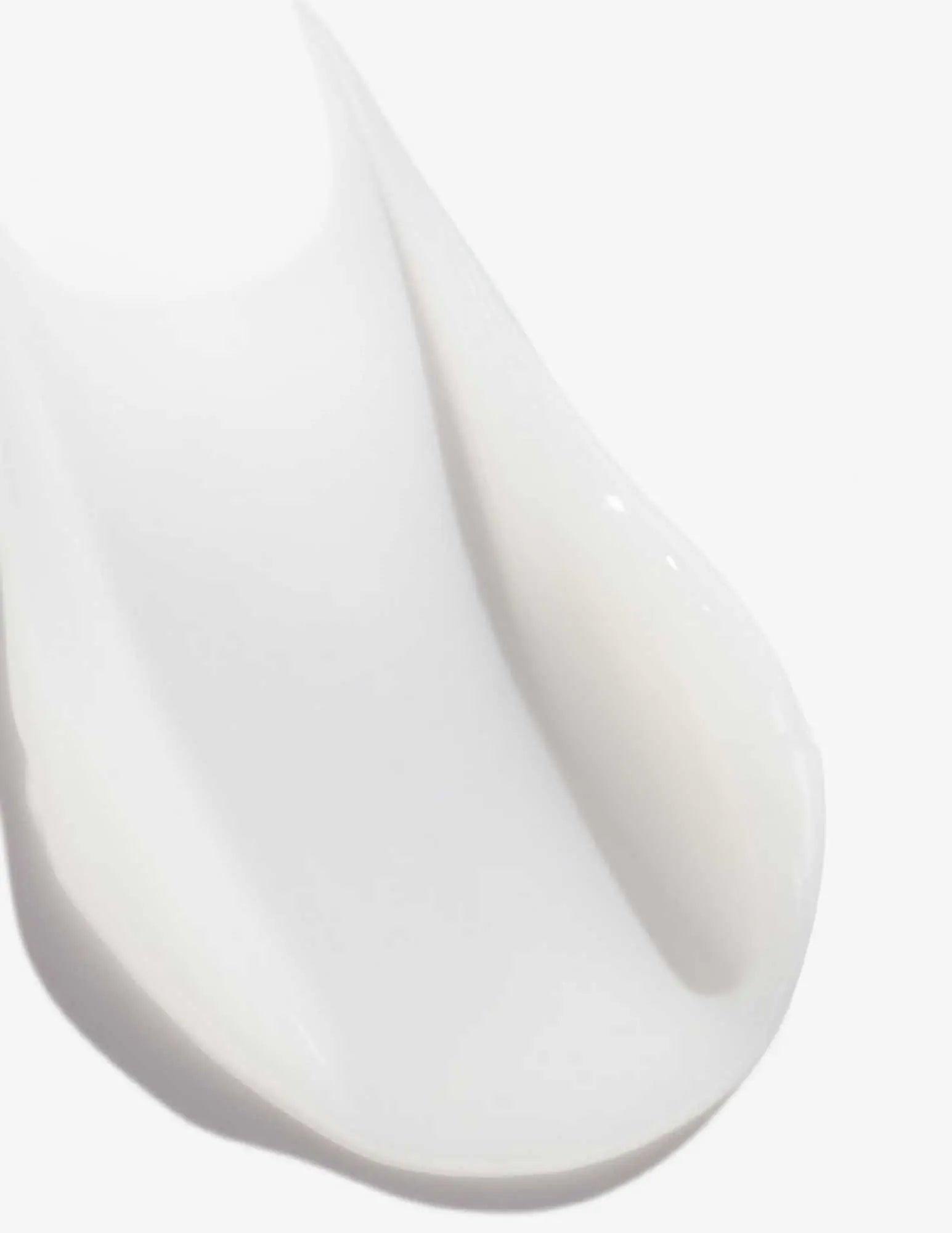 Close-up of Redken Acidic Perfecting Concentrate Leave-in Treatment, showcasing its creamy, smooth texture.