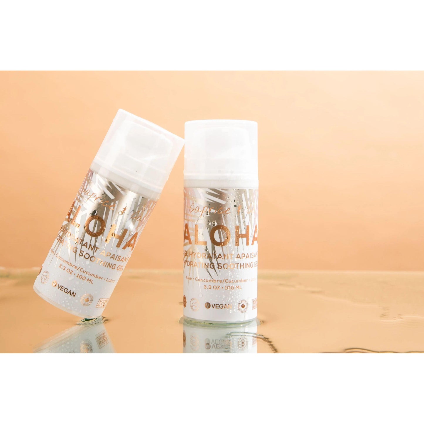 Aloha Aloe + Lotus Soothing Gel in two bottles with a reflective surface, showcasing a vegan, hydrating skincare product.