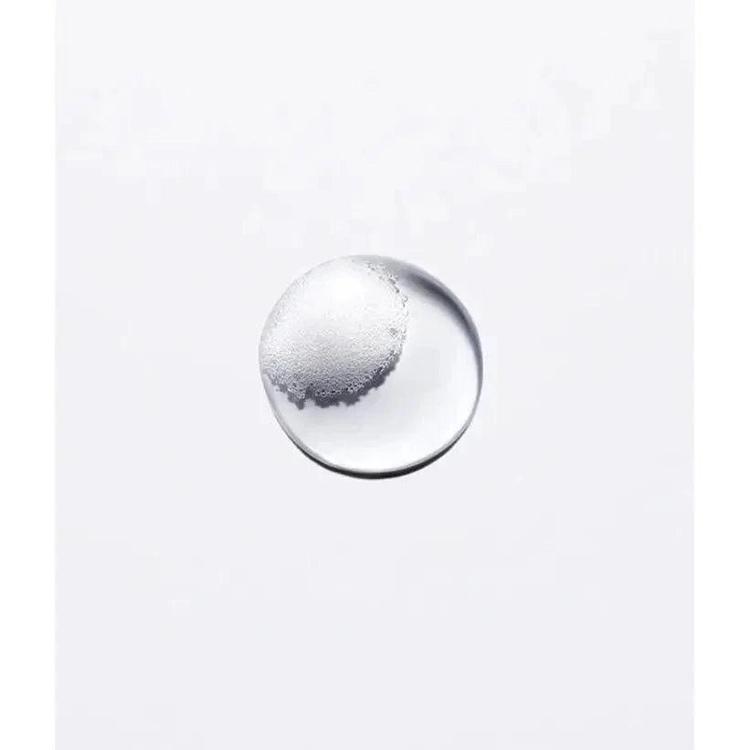 Single clear liquid bubble on a white background