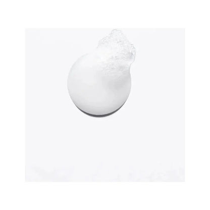 Close-up of white foam cleanser on a light background.
