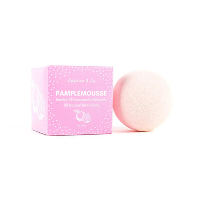 All natural bath bomb in pink packaging featuring grapefruit scent, perfect for soothing and cleansing the skin.