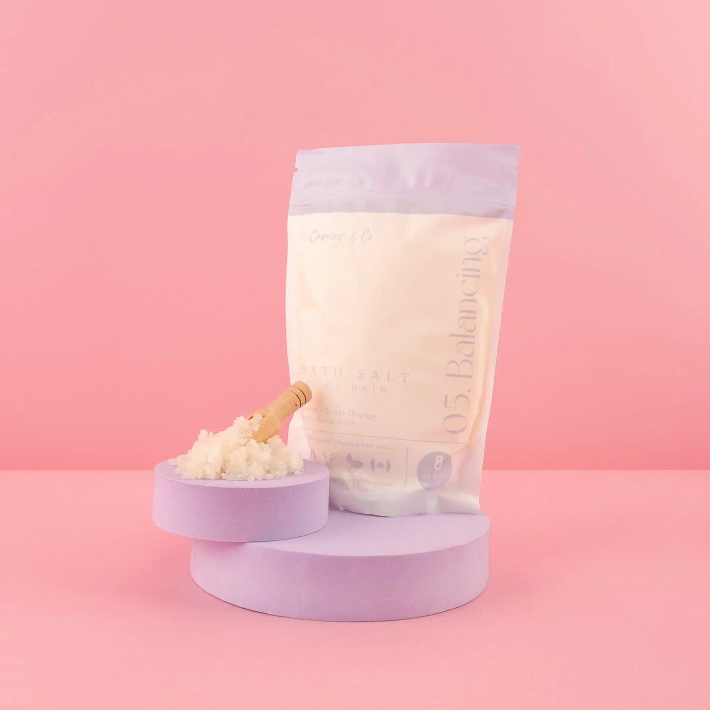 All Natural Bath Salts with soothing essential oils in a stylish package on a pastel background.