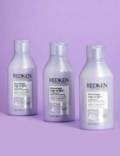 Redken Blondage High Bright Conditioner bottles for vibrant blonde hair care on a lavender background.