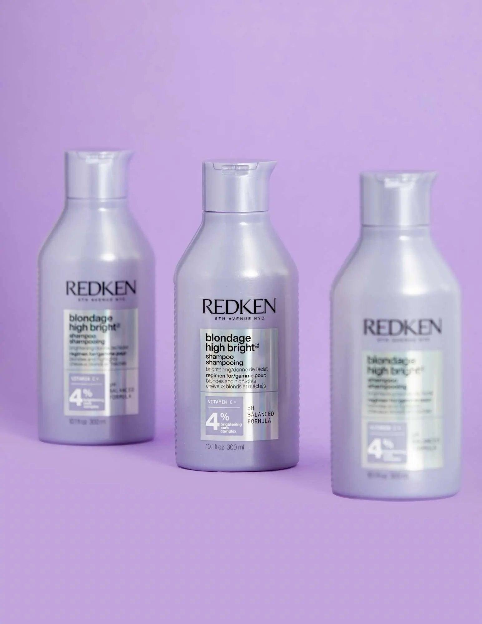 Three bottles of Redken Blondage High Bright Shampoo against a purple background, ideal for vibrant blonde hair.