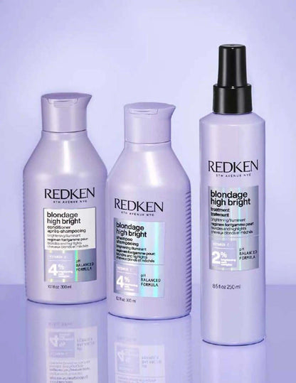 Redken Blondage High Bright Shampoo and conditioner bottles on a purple background, designed for vibrant blonde hair care.