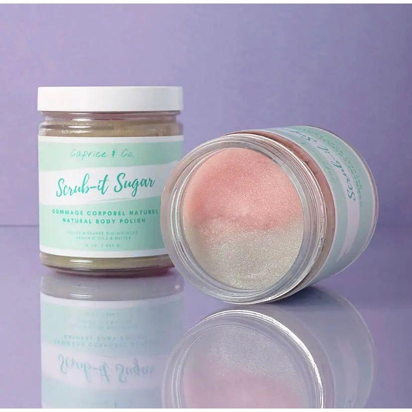 Natural sugar body scrub in jar, featuring cotton candy scent and organic ingredients, displayed on a pastel background.