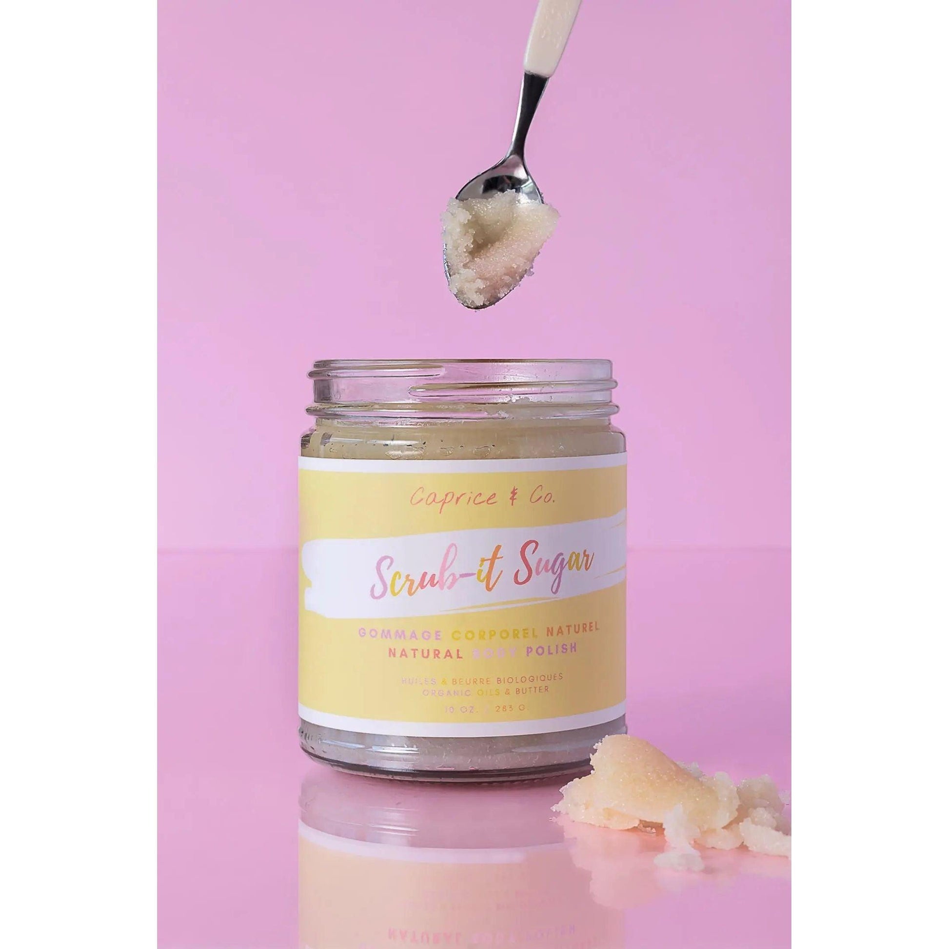 Natural sugar scrub in jar with spoon, featuring vibrant "Fruit Loops" scent and infused with organic oils.