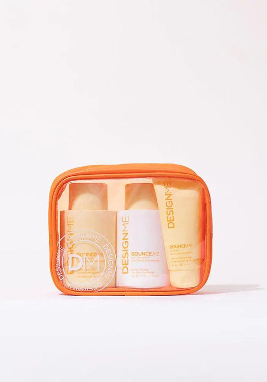BOUNCE.ME Curl Glitz Kit featuring shampoo, conditioner, and curl balm in a vibrant orange pouch. Perfect for defined curls.