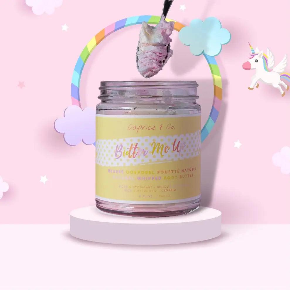 Jar of Butter Me Up Fruit Loops body butter with a scoop, surrounded by whimsical clouds and a rainbow backdrop.