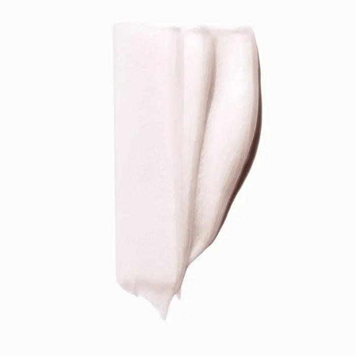 Skincare cream swatch showing white, creamy texture on a white background.