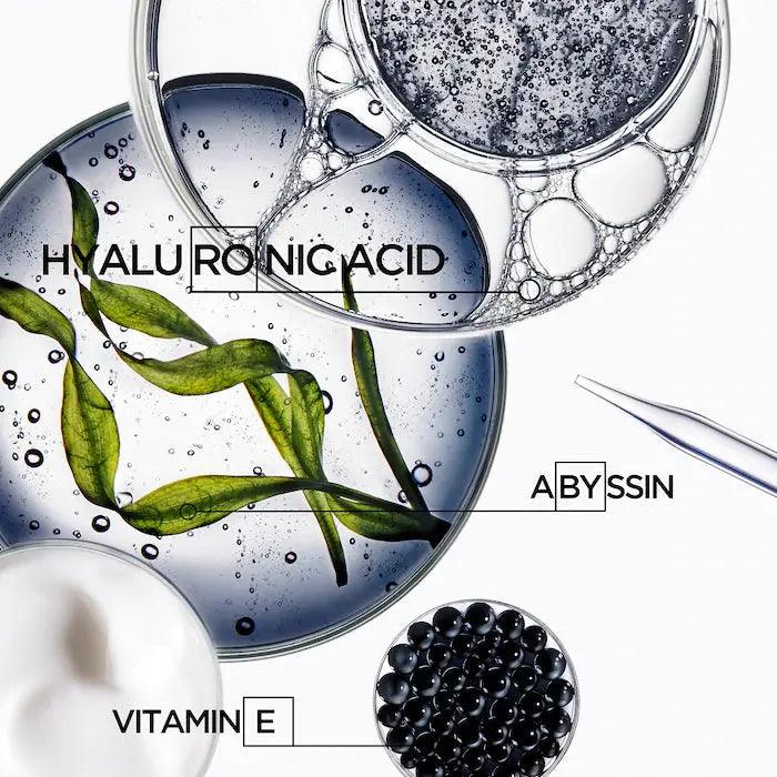 Ingredients including hyaluronic acid, abyssin, and vitamin E in a clear gel with green leaves and bubbles.