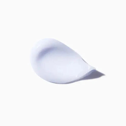 Creamy white skincare lotion drop on white background