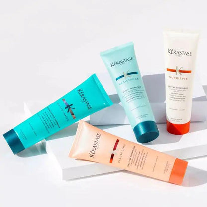 Kerastase hair care products - shampoo, conditioner, and treatment tubes on white background for healthy and nourished hair.