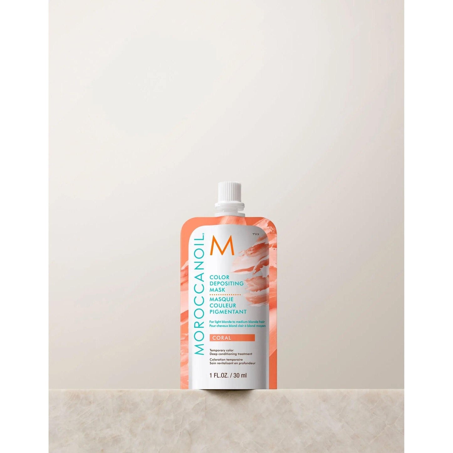 Moroccanoil Color Depositing Mask 30ml in Coral packaging, designed to enhance hair color and shine with argan oil.