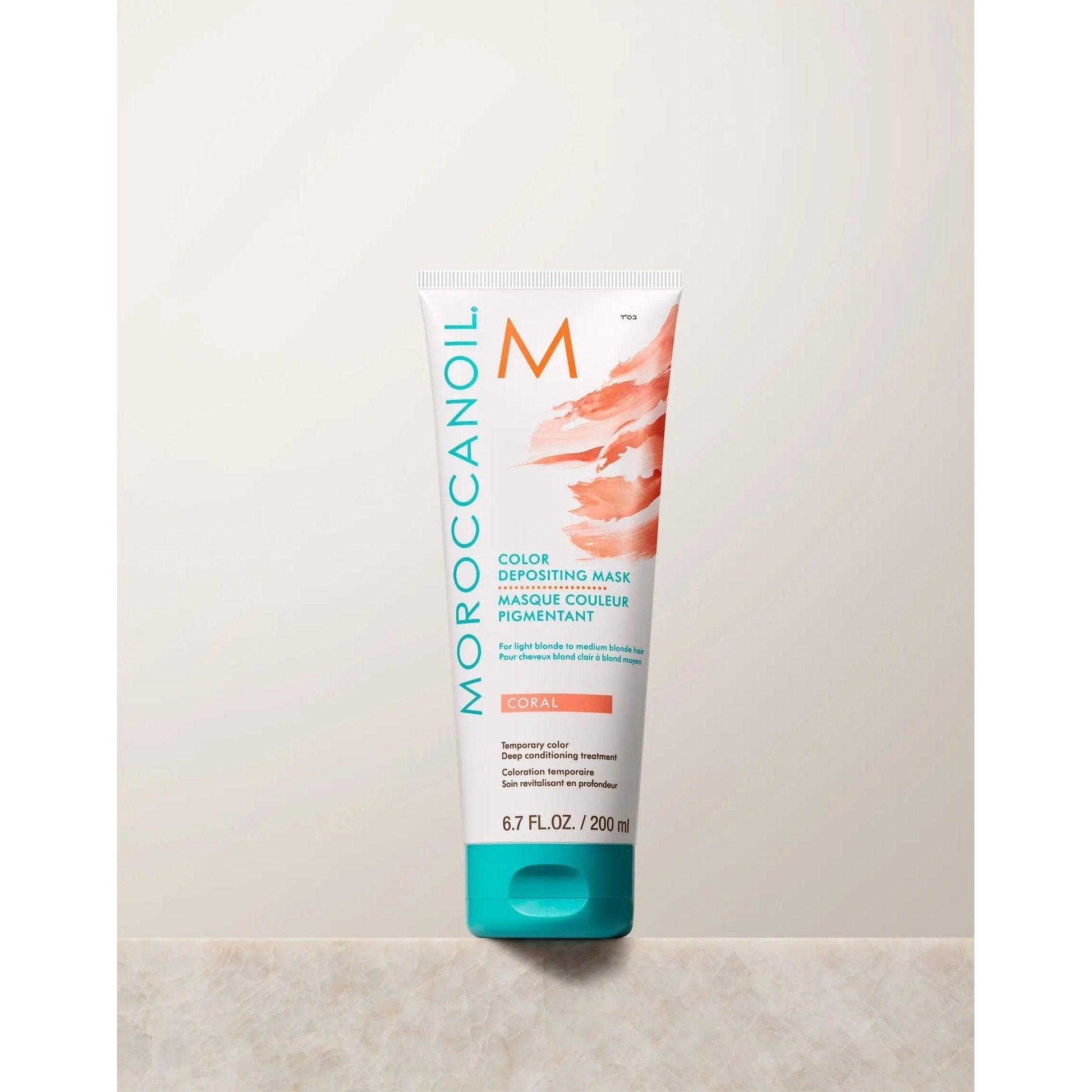 Moroccanoil Color Depositing Mask in Coral, 6.7 fl. oz. tube for vibrant hair color and deep conditioning benefits.