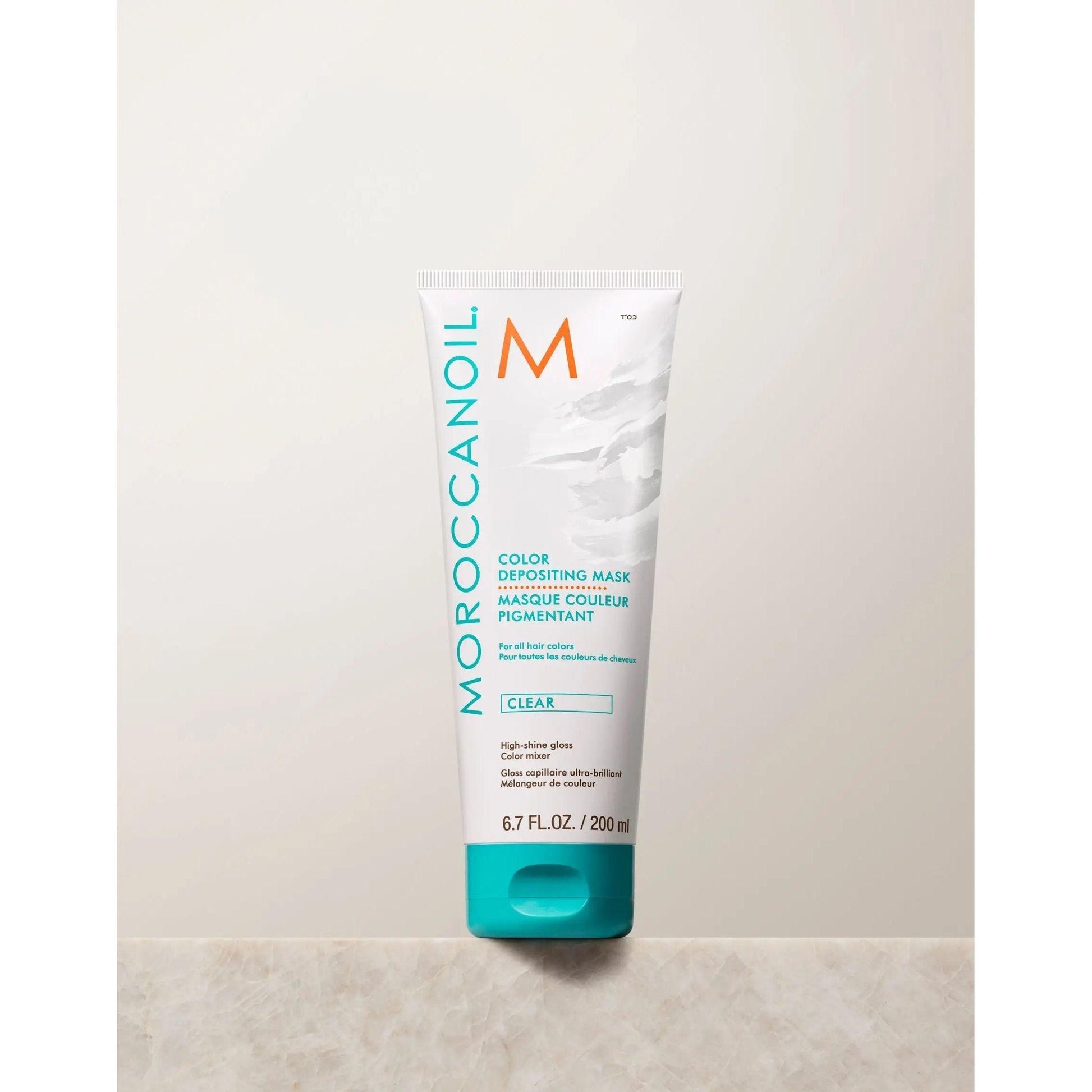 Moroccanoil Color Depositing Mask in clear, 200 ml tube for rejuvenating hair color and deep conditioning.