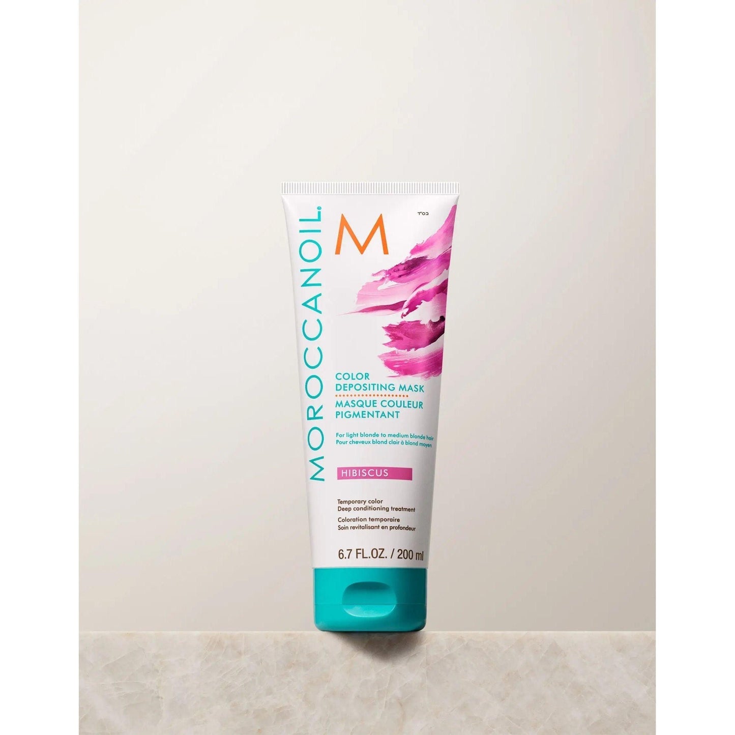 Moroccanoil Color Depositing Mask in Hibiscus, rejuvenates hair color and adds shine, 6.7 fl oz.