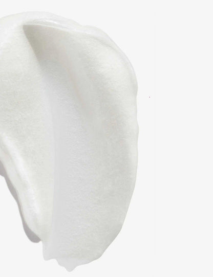 Creamy texture of Redken Color Extend Magnetics Conditioner on a white background. Ideal for color-treated hair.