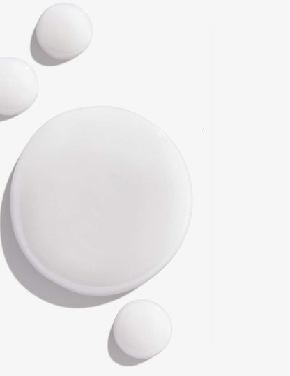 White drops of shampoo representing Redken Color Extend Magnetics Shampoo's creamy texture and formula.