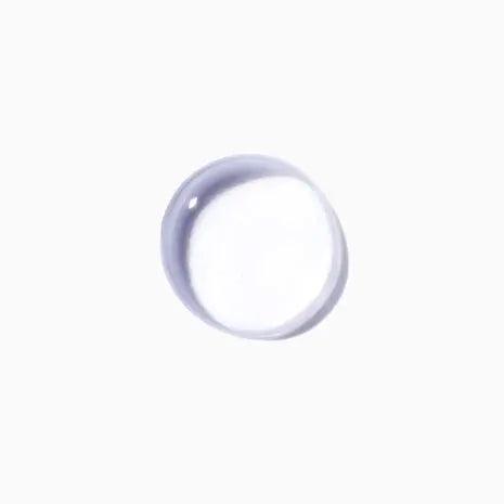 Transparent gel droplet from Kérastase Cure Apaisante Intense scalp treatment, showcasing its soothing texture.
