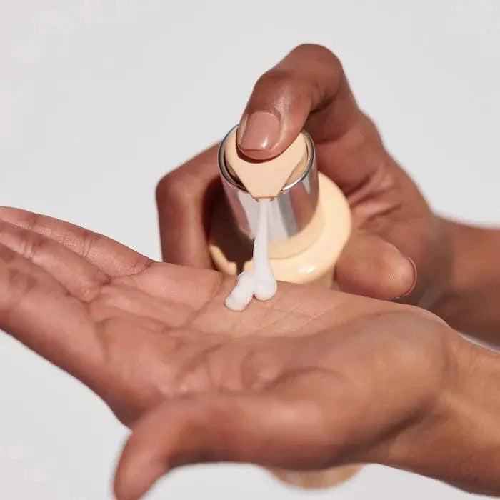 Hand dispensing Curl Manifesto Gelée Contour from a pump bottle, showcasing its creamy texture.