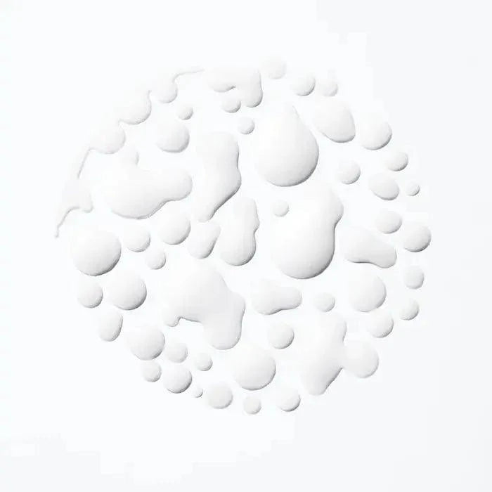 White droplets on a light background, creating a textured circular pattern.