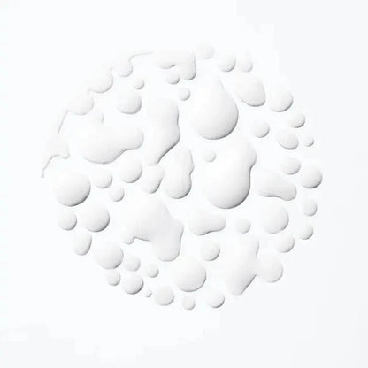 White droplets on a light background, creating a textured circular pattern.